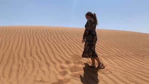 Megan Bennett walking across the desert in Oman