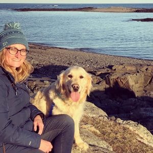 Whitney McKay and her dog by a lake
