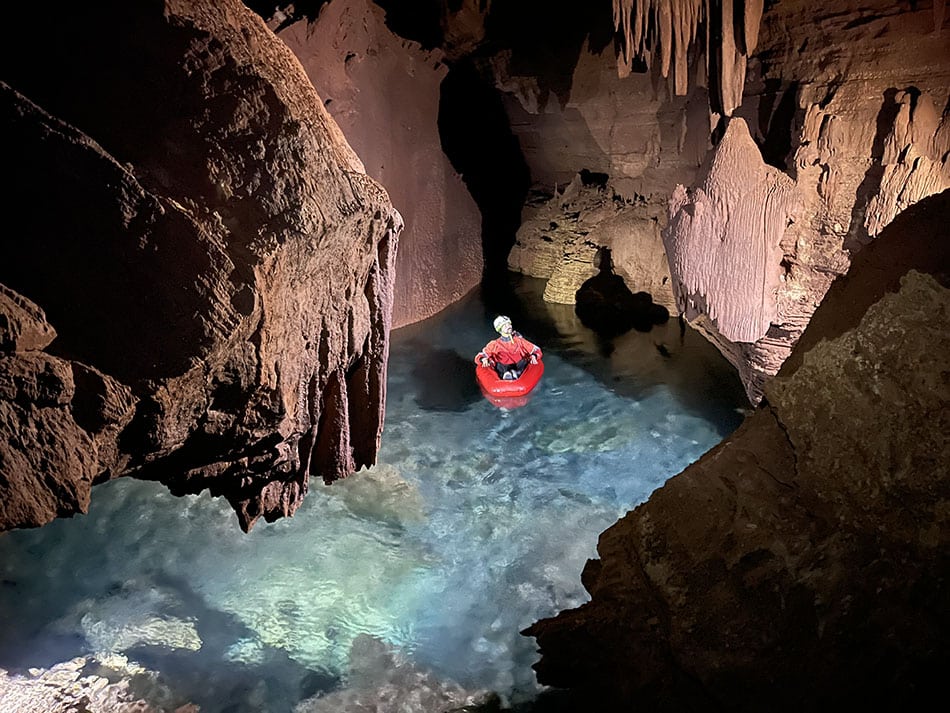 A researcher on a raft in a flooded cave in the Grand Canyon.