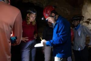 Professor with students inside a cave in Brazil