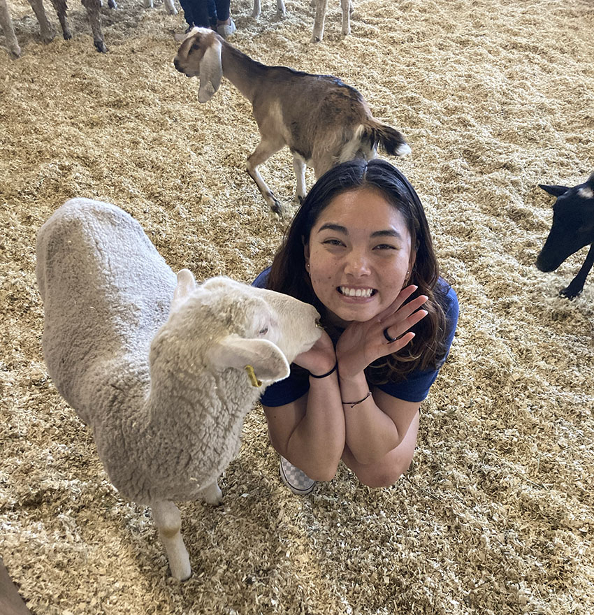 Fiona at a petting zoo with a goat