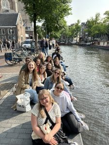 NAU students sitting next to a river in northern Europe