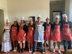 Students wearing chef hats and aprons during a study abroad program