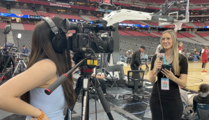 Students reporting on the sidelines