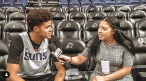 Student interviewing athlete