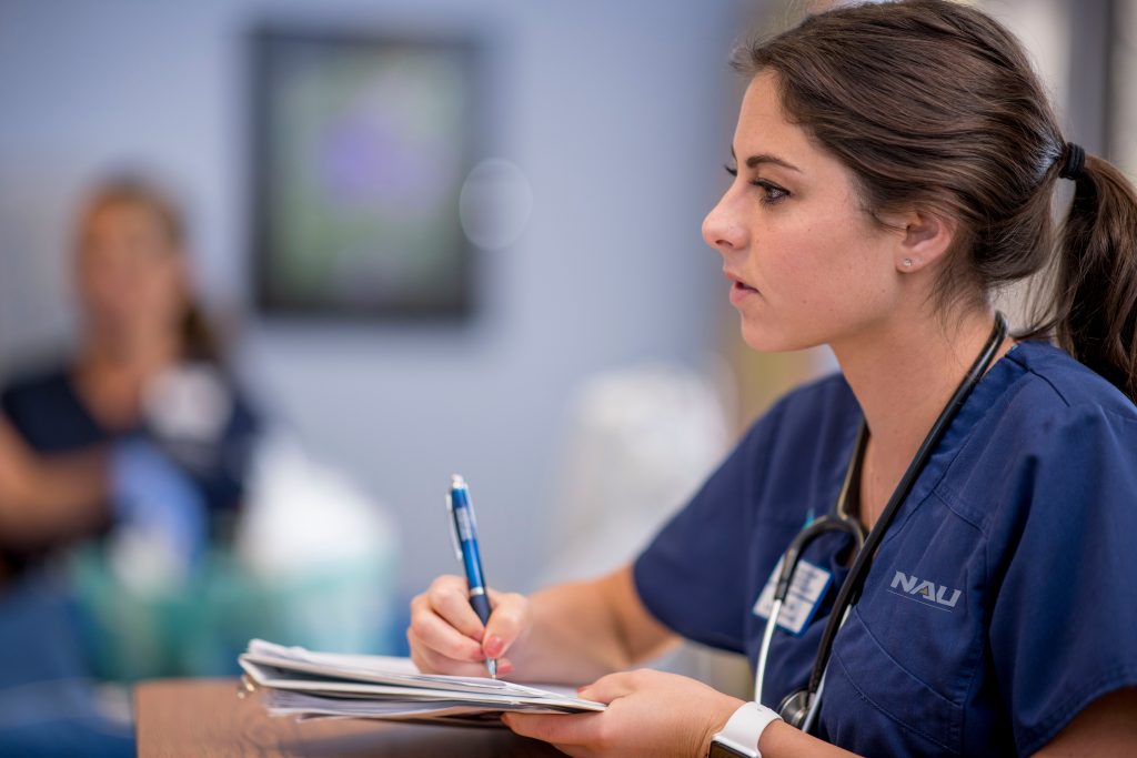NAU nursing student taking notes