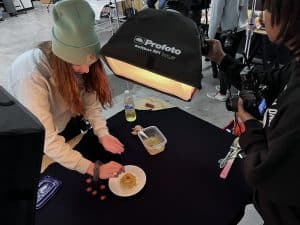 Student preparing a plate for a photo shoot