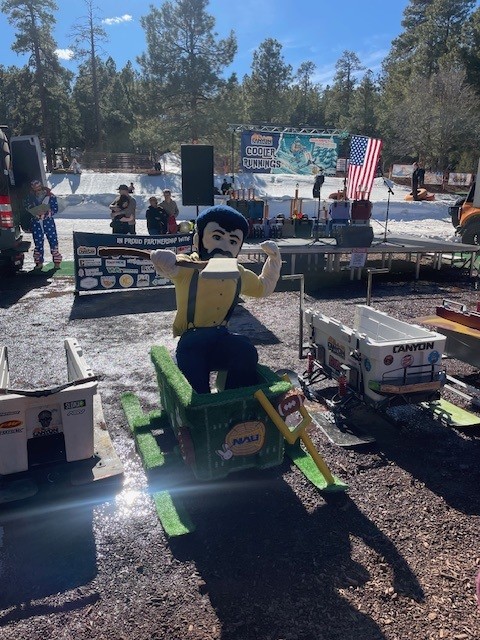 Louie the Lumberjack sits in a Canyon Cooler bobsled.