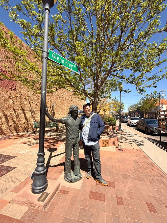 Aaron Kimbrell in downtown Winslow by the "Standing on a Corner" statue