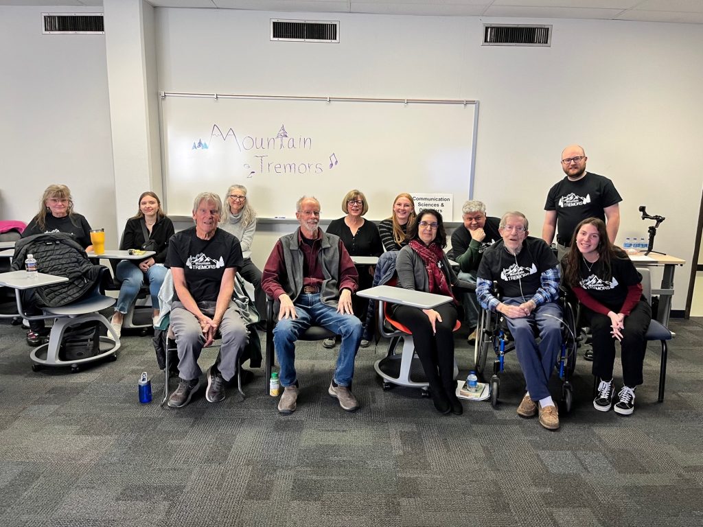 Students and seniors sitting at desks in a classroom in front of a whiteboard that says Mountain Tremors