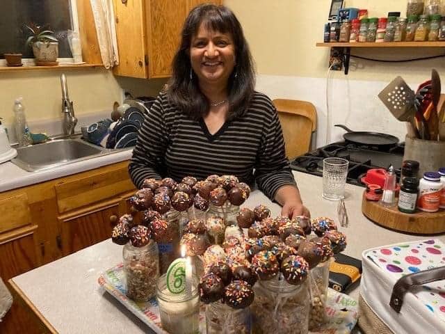 Ramona Mellott in her kitchen posing with homemade cake pops