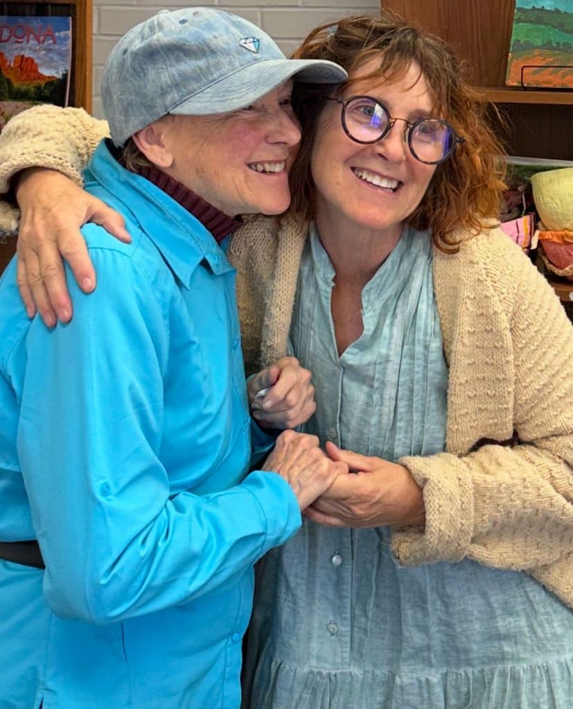 Two older adults hugging